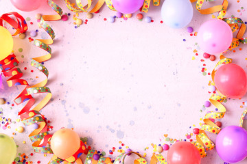 Balloons and party streamers on festive background