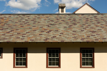 Slate stone roof details of a historic mission style stucco barn in North Carolina