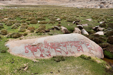 Stone with mantras on the Tibetan plateau