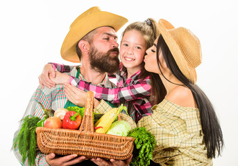 Parents and daughter farmers celebrate harvest holiday. Family farm concept. Family farmers hug hold basket fall harvest. Family gardeners basket harvest isolated white background. Family gardening