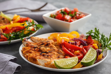 Grilled chicken fillet with sauteed peppers and onion.