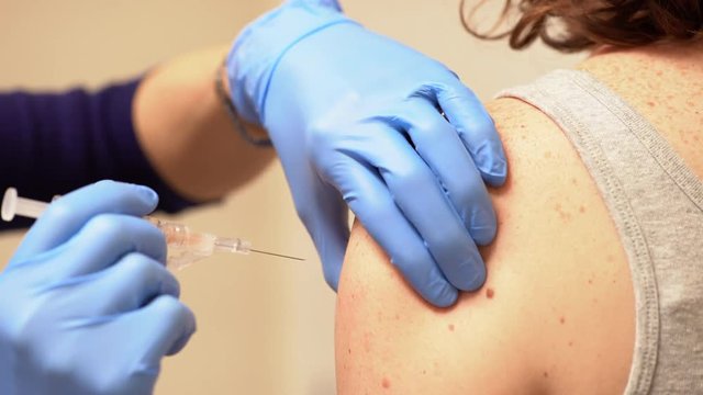 Healthcare Professional Administers A Flu Vaccine