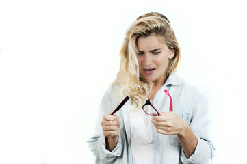 very beautiful young girl broke glasses and holds them in her hands on a white background