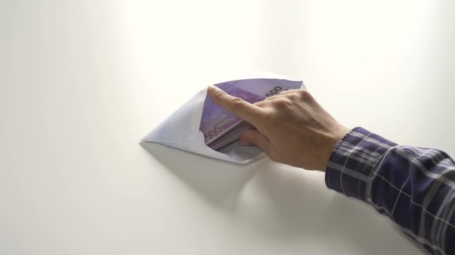 Envelope bribe find in in folders with documents on table the money banknotes in nominal of 500 euros.