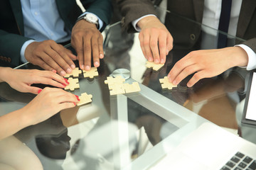 close up .multinational business team assembling puzzle.