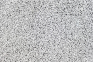 Texture of decorative plaster with a relief. White plaster. Close-up.