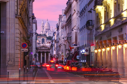 Sacre-Coeur Basilica and Notre-Dame de Lorette church at pink sunset, seen from Rue Laffitte, Paris, France
