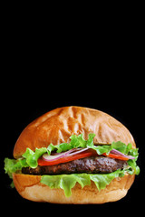 burger isolated on black. burger with salad tomatoes onion and pikles