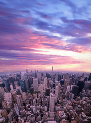 Aerial view of Manhattan skyscraper from Empire state building observation deck. Pink sunrise