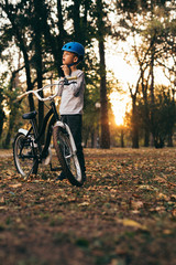 Plakat cute little boy with his bike in park