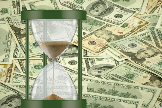 hourglass on dollars background