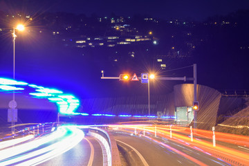 The car light trails in front of a tunnel at Lugano