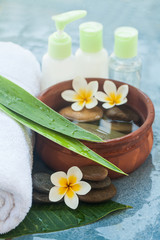 Obraz na płótnie Canvas Flowers, stones and cosmrticsfor massage treatment