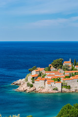 Fototapeta na wymiar Springtime blue water landscape view of St. Stephan island in Adriatic Sea in Montenegro, famous tourist and holiday destination in Europe with stunning architecture and crystal sea waters