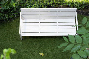 white wooden bench in green park. top view chair