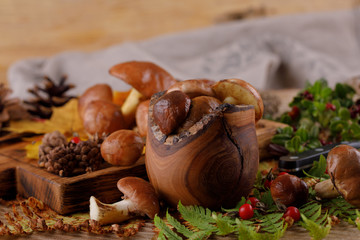 Harvest fresh mushrooms on a wooden background.