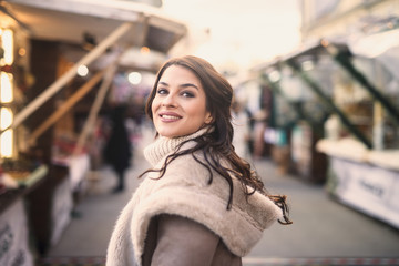 Woman posing while standing on the street. Christmas holidays concept.