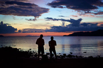 Silhouette of couple watching sunset