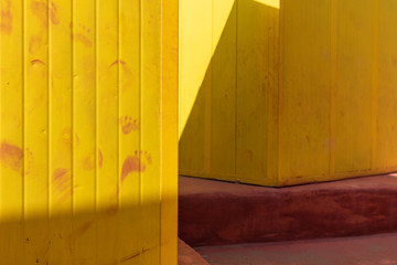 Beautiful yellow Bathing houses on sandy beach. Empty shelters on a sunny but moody day. Seaside architecture, colored paint, maze like labyrinth. Homelessness and lonely places.