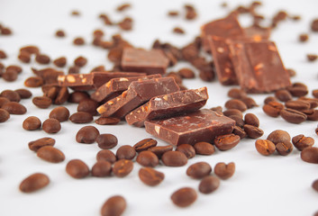 close up.pieces of chocolate and coffee beans isolated on white.