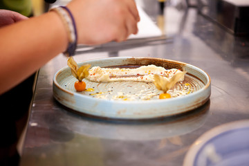 Chef preparing food meal in kitchen restaurant. Chef decorating dish