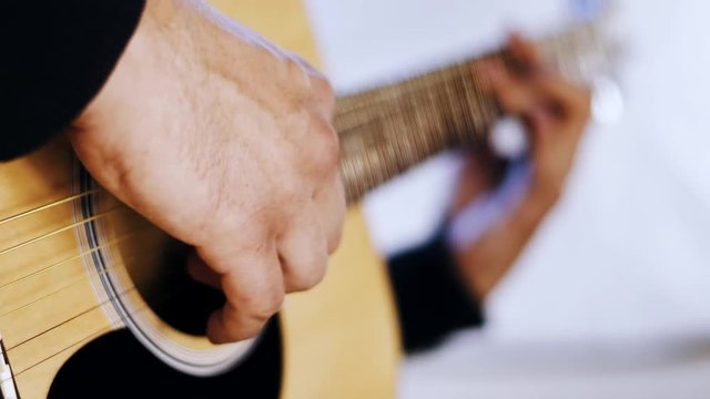 Man playing guitar close up on the white background