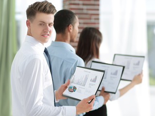 business team financial report standing in a modern office