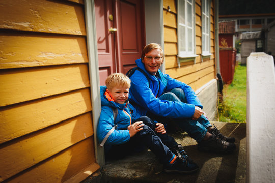 Father And Son Near Traditional Wooden House In Norway, Family Travel