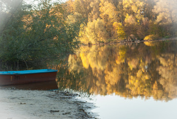 lake with a beautiful reflection of trees with yellow foliage