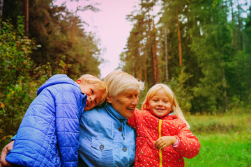 happy grandmother and grandkids enjoy being together in nature