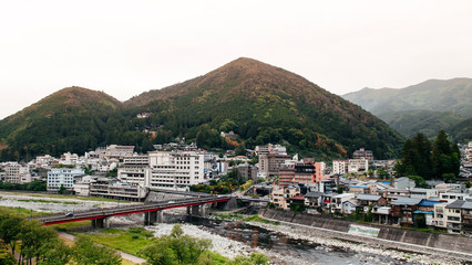 Fototapeta na wymiar Natural river and mountain of Gero onsen resort town in Gifu, Japan - autumn season