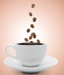 coffee beans falling into cup