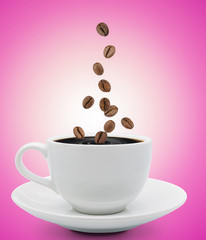 coffee beans falling into cup
