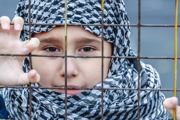 a refugee girl from the east in a headscarf