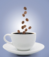 coffee beans falling into cup