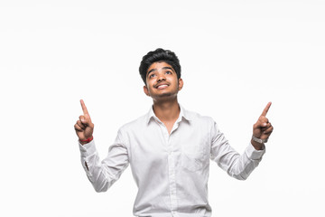 Indian Businessman looking up, pointing with hands up at copyspace isolated over white background