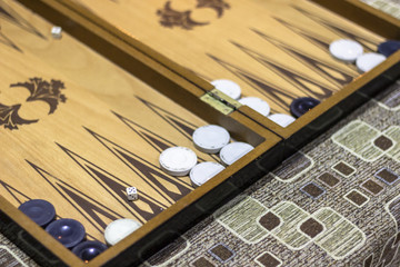 Close-up angled shoot of dice of backgammon under dim light