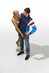 Fashion woman body. The man hugging mannequin at studio, perfect woman dream concept