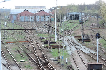 Railway tracks and some buildings where trains are repaired - obrazy, fototapety, plakaty