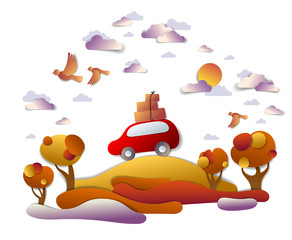 Car travel and tourism in autumn, red minivan with luggage riding off road in orange fall meadows among trees, birds and clouds in the sky, paper cut vector illustration of auto in scenic landscape.