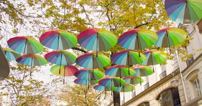 Rainbow umbrellas above the street in Paris, France