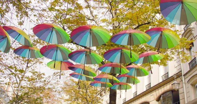 Rainbow umbrellas above the street in Paris, France