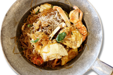 Top view of baked crab vermicelli with pepper in the pot, isolated on white background. Thai foods concept.