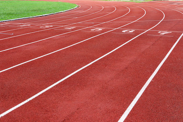 Photo of red running track for competition or exercise, as background. Sports concept. Colorful...