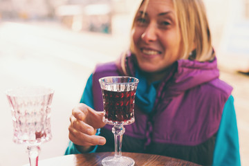 Woman holding a glass of red wine.