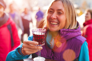 Woman holding a glass of red wine.