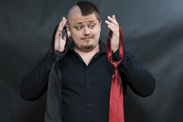 Punk. On the hands hang two ties. Facial expression is indecisive and thoughtful. Which is better...