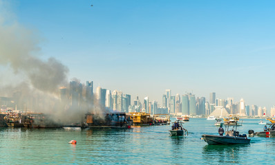 Fototapeta na wymiar Traditional arabic dhow on fire in Doha, Qatar