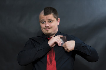 Punk. Dark shirt and red tie. The right hand puts the purse in a shirt pocket. On the face smile...