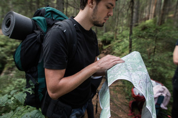 people on the hike are looking for a way on the map